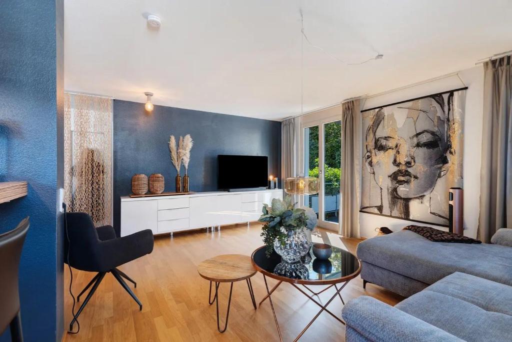 a living room with a couch and a tv at Fewo SPECTRUM II in Uhldingen-Mühlhofen