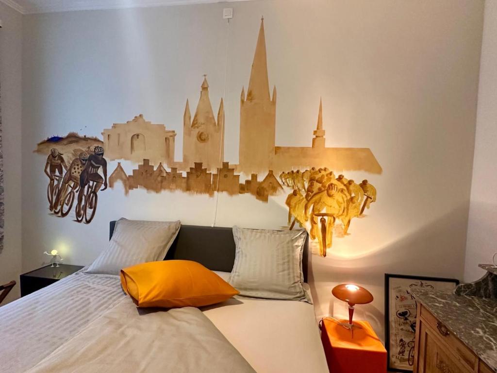 a bedroom with a bed with a castle on the wall at In De Wulf in Ieper