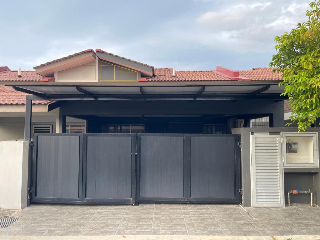 a house with a gate in front of it at Nafisa Homestay in Kepala Batas