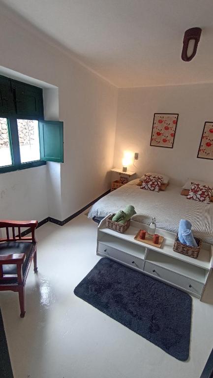 a bedroom with a bed with a tray of food on it at Olala House Lanzarote in Haría