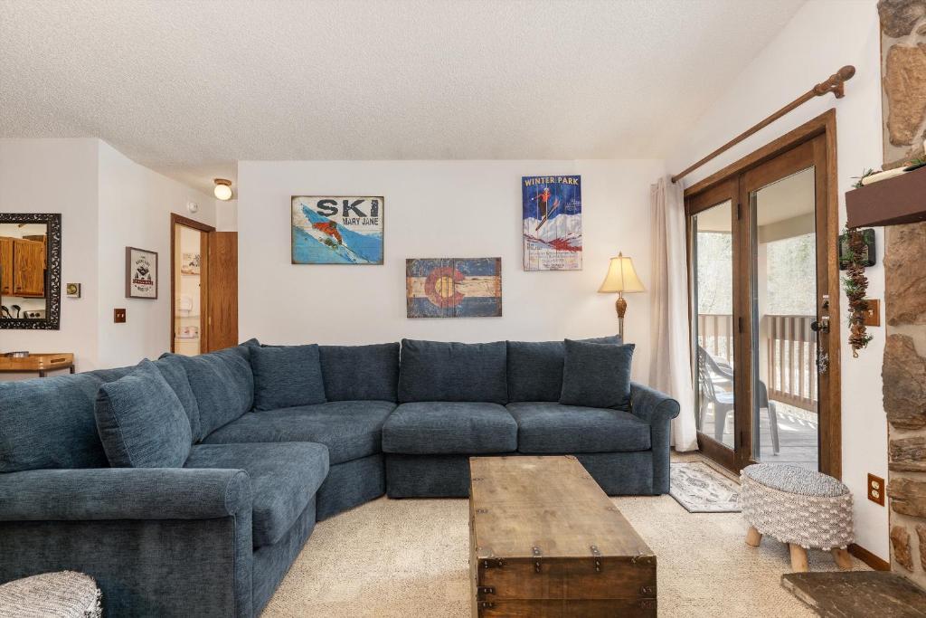 a living room with a blue couch and a table at Silverado II Unit 334 in Winter Park