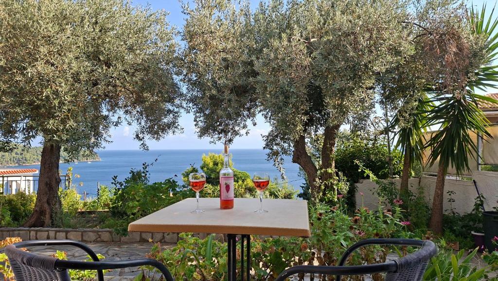 a table with two glasses of wine on it at Ninareti Studios in Agia Paraskevi