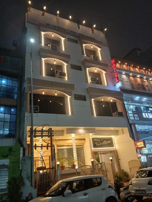 a white car parked in front of a building at Hotel Valentines in Prayagraj