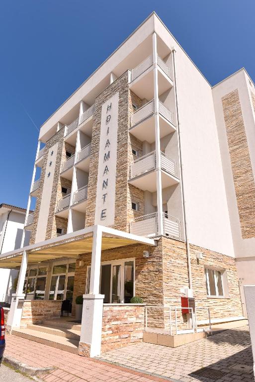 a building with a sign on the side of it at Nuovo Hotel Diamante in Cesenatico