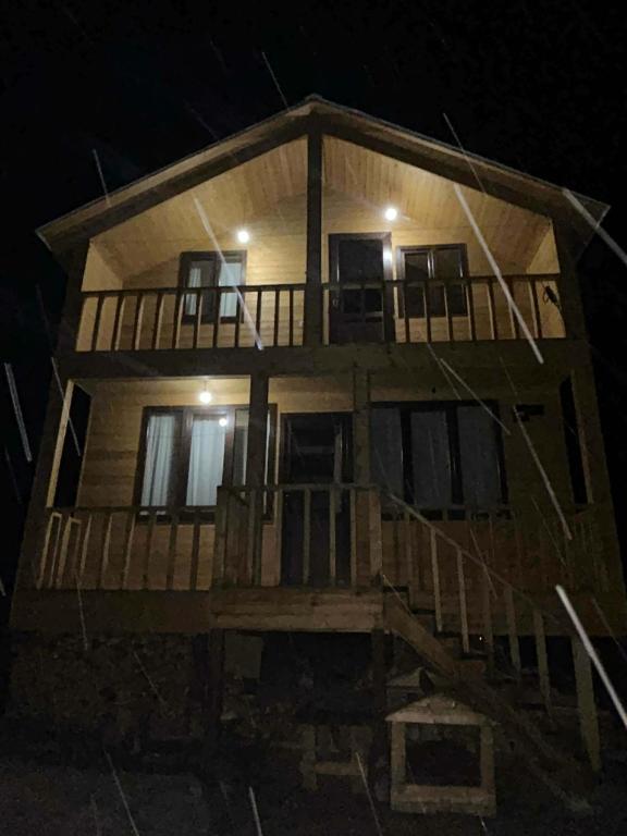 a large wooden house at night at Cottage SUNNY in Itʼkhvisi