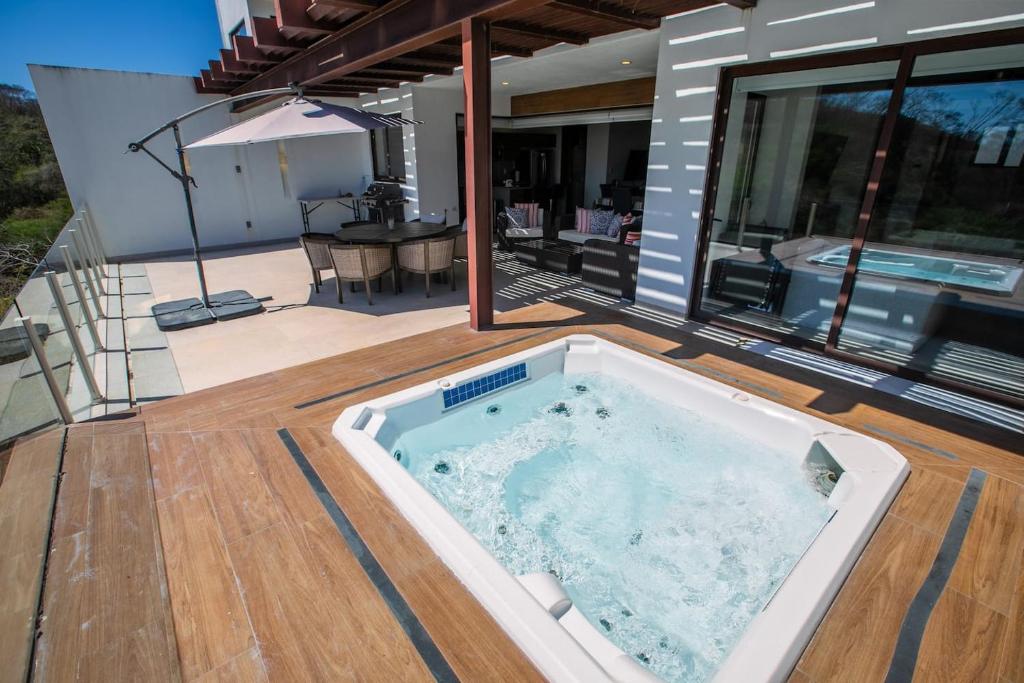 a hot tub on the deck of a house at Alamar Vallarta in Cruz de Huanacaxtle