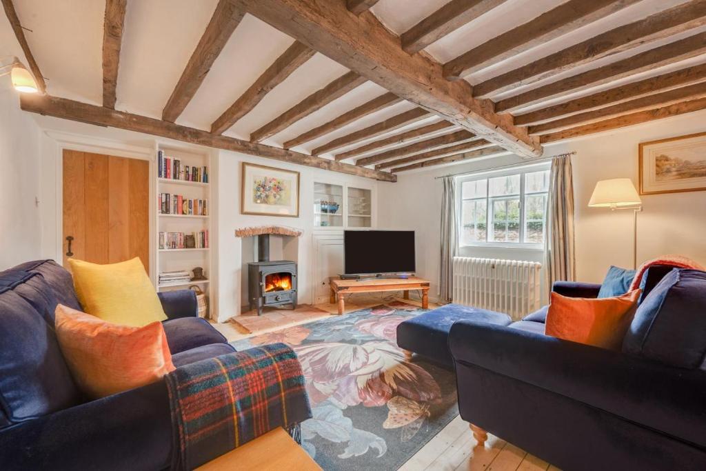 a living room with two couches and a fireplace at 4 Bed in Westleton oc-holc in Westleton