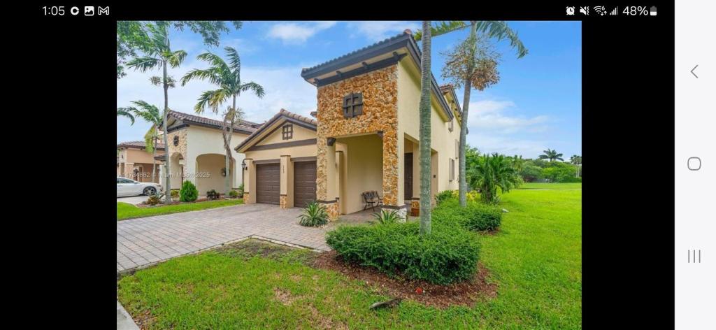 a house with a car parked in front of it at Atlas in Homestead