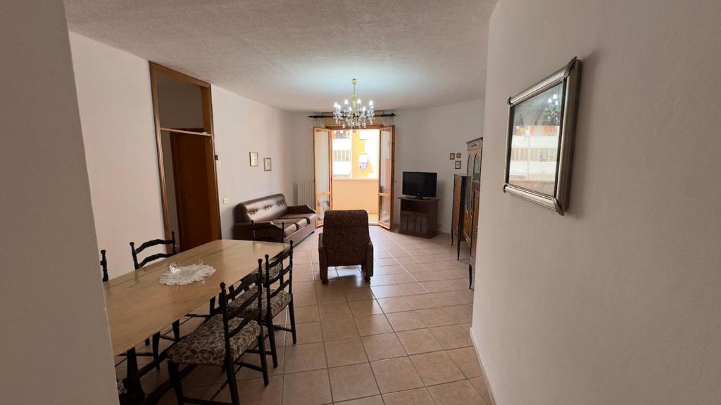 a living room with a table and chairs and a couch at Tre Archi Sea Home in Lido di Fermo