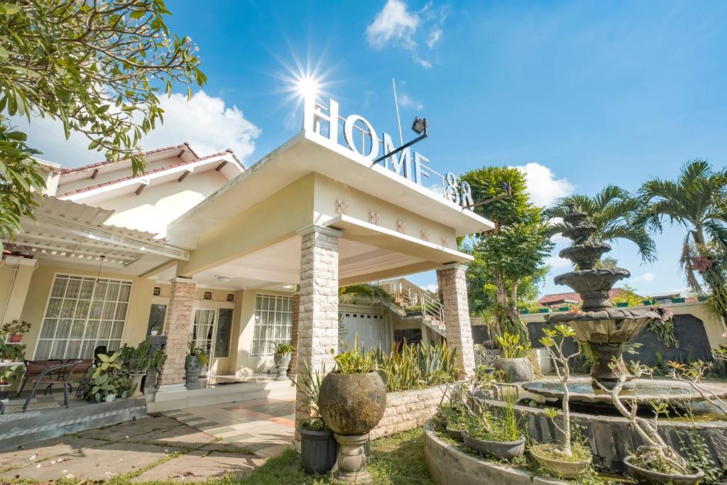 a house with a sign on top of it at HOME 88 Feels Like Home in Sleman