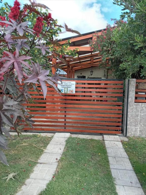 a fence in front of a house with flowers at Nahomi House in Barrio Félix U Camet