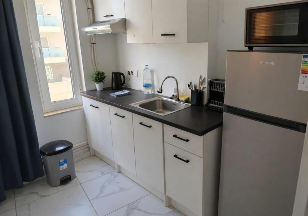 a kitchen with a sink and a refrigerator at Kalimera Studios in Hamrun
