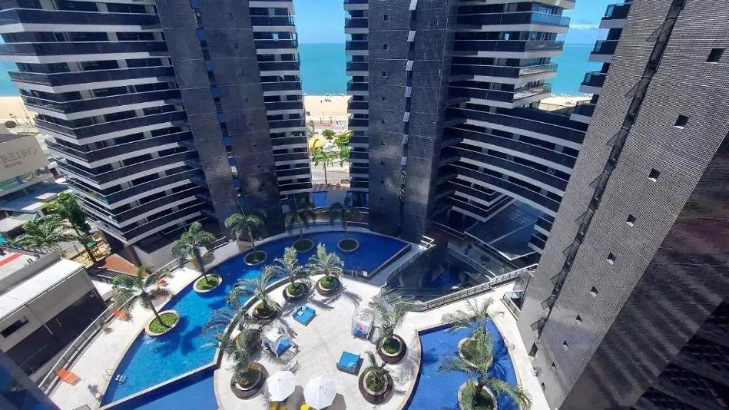 an aerial view of a pool in the middle of two tall buildings at Landscape Beira Mar in Fortaleza