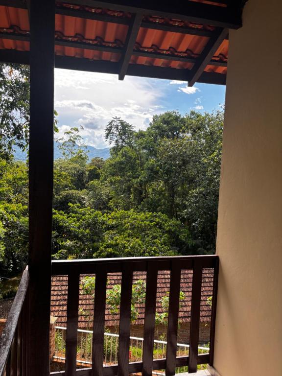 a balcony with a view of the trees at Casa na Natureza Próx Pomerode e Timbó in Rio dos Cedros