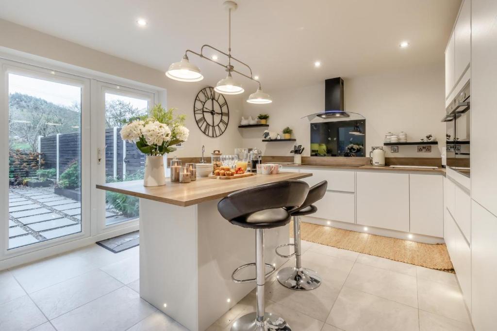 a kitchen with a counter and a bar with a stool at 3 Bed in Brithdir oc-c33971 in Llanfachreth