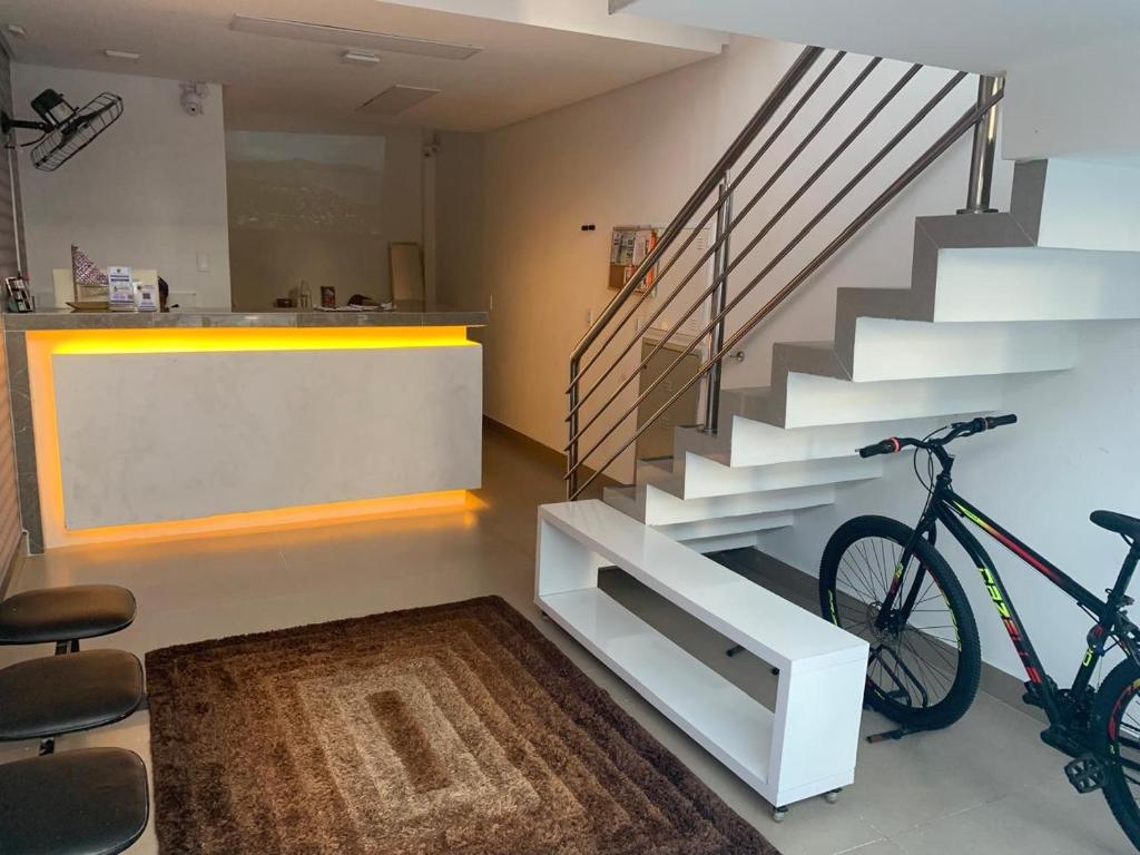 a bike parked next to a staircase in a room at Pousada Pergentino in Maceió