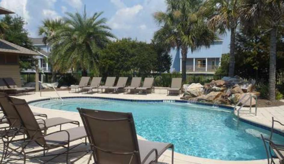 a swimming pool with chaise lounge chairs and a swimming pool at Hello Sunshine in Santa Rosa Beach