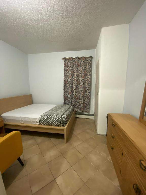 a small bedroom with a bed and a window at private room in Paterson