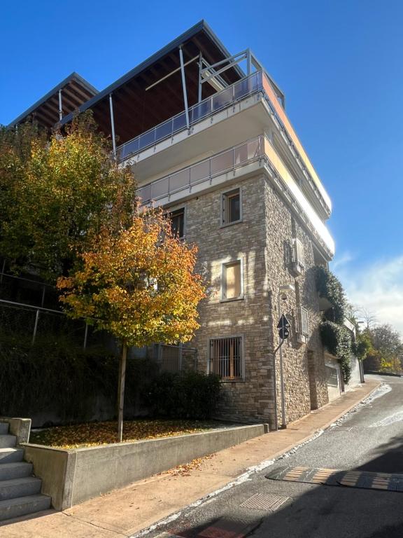 a building with a tree in front of it at Respiro di Bosco in Robbiate