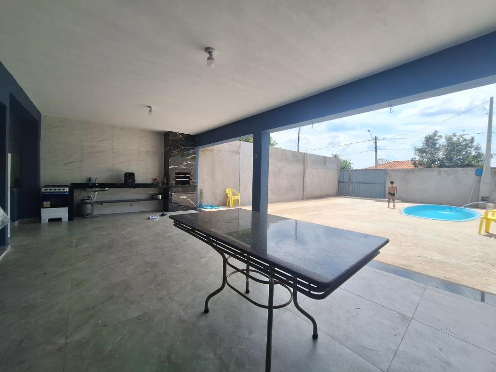 a glass table in a living room with a playground at Diony in Brotas