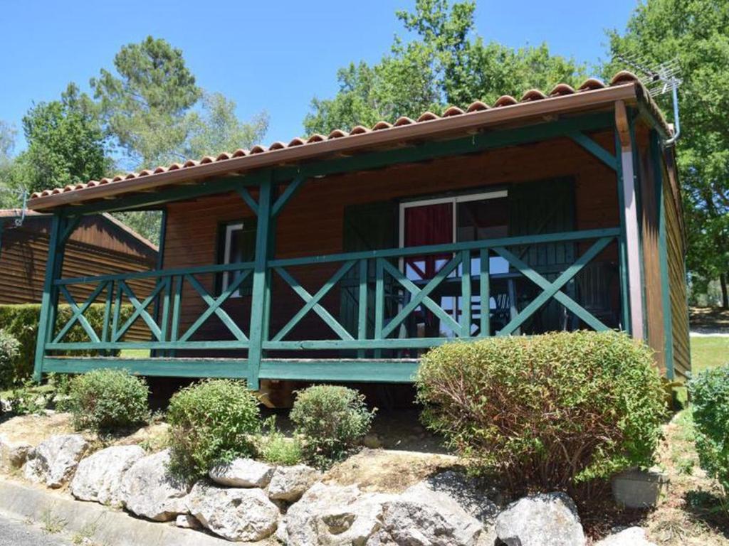 a log cabin with a porch and a balcony at Chalet 35m² avec Terrasse, 2 Chambres - API-1-52-1014 in Boulogne-sur-Gesse
