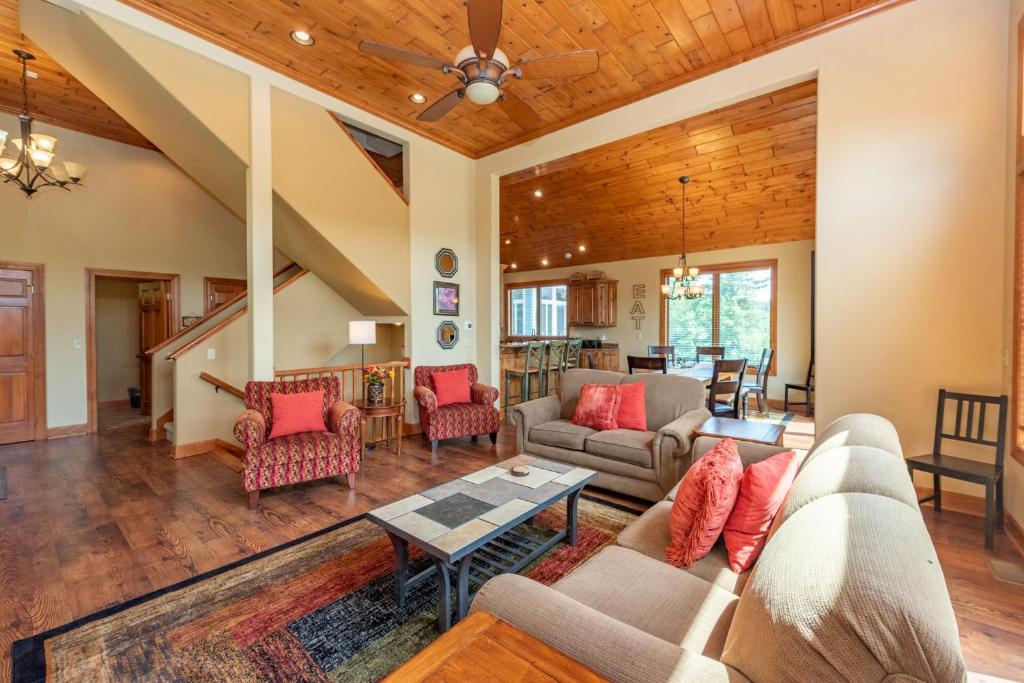 a living room with a couch and a table at Firefly Cove by Railey Vacations in McHenry