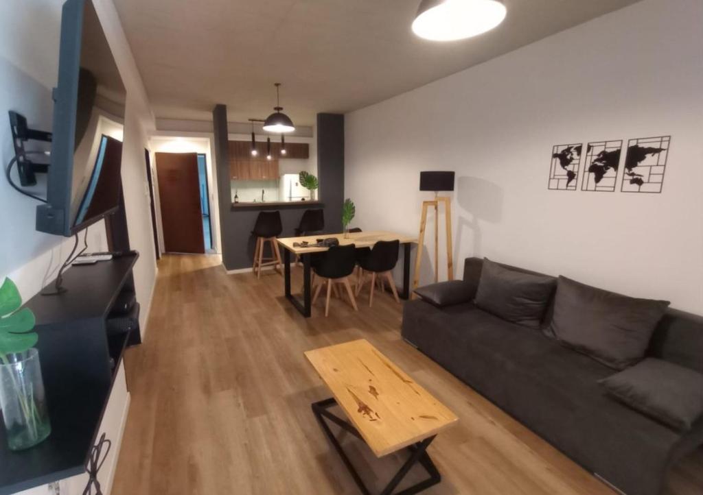 a living room with a couch and a table at Departamen dos ambientes in Buenos Aires