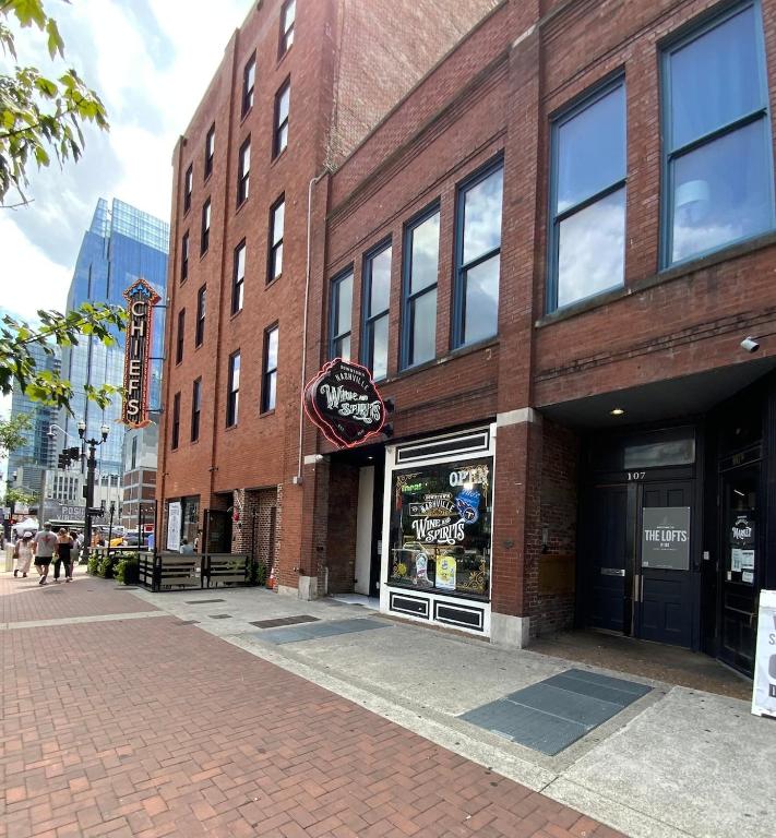 a brick building with a store on a street at The Lofts at 107 in Nashville