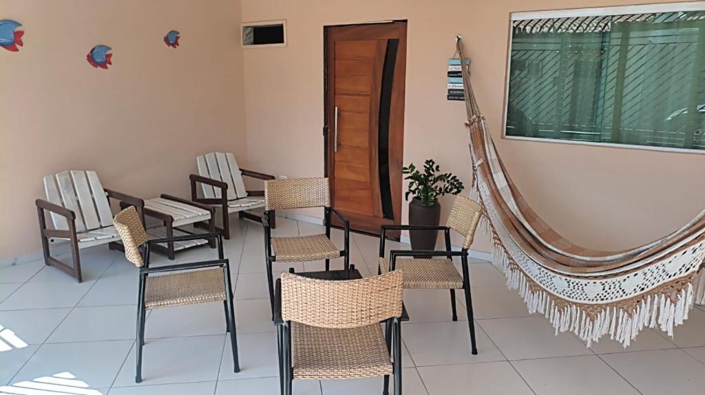 a room with chairs and a table and a window at Flat 2 Marias in Maragogi