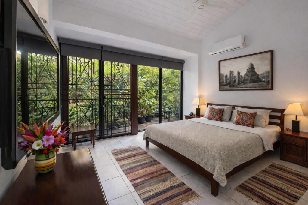 a bedroom with a bed and a large window at 519@jamtree in Colombo