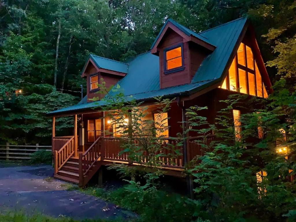a log cabin with a wrap around porch and a wrap around deck at A Bear's view in Sevierville