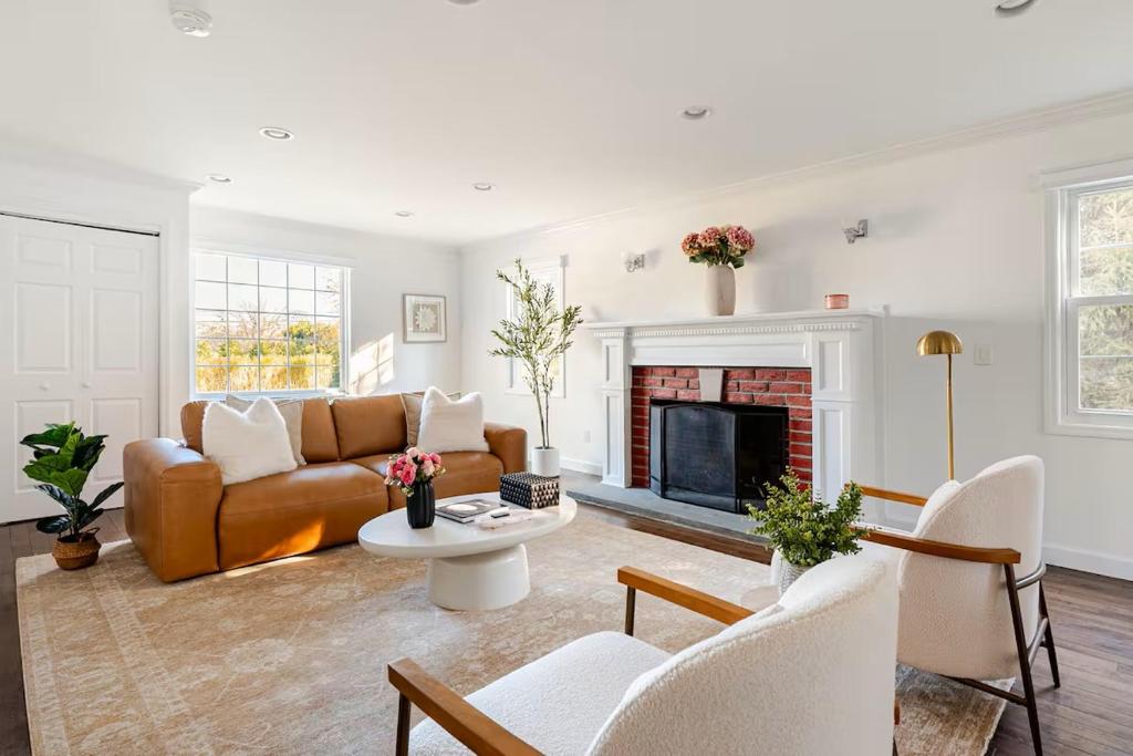 a living room with a couch and a fireplace at Norwalk Retreat in Norwalk
