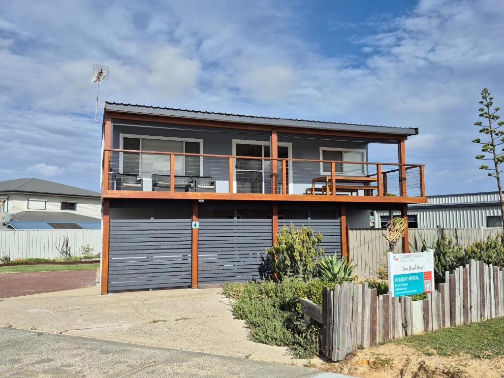 a house with a garage and a fence at Lano Beach House in Lancelin