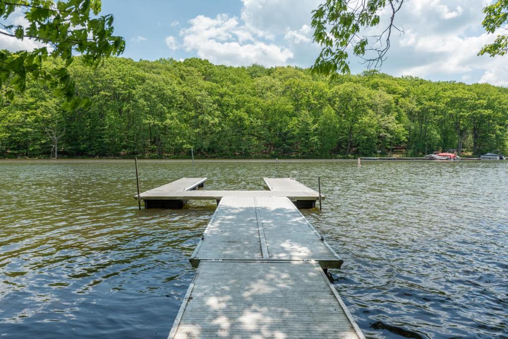 a dock in the middle of a lake at Happy Times by Railey Vacations in Swanton