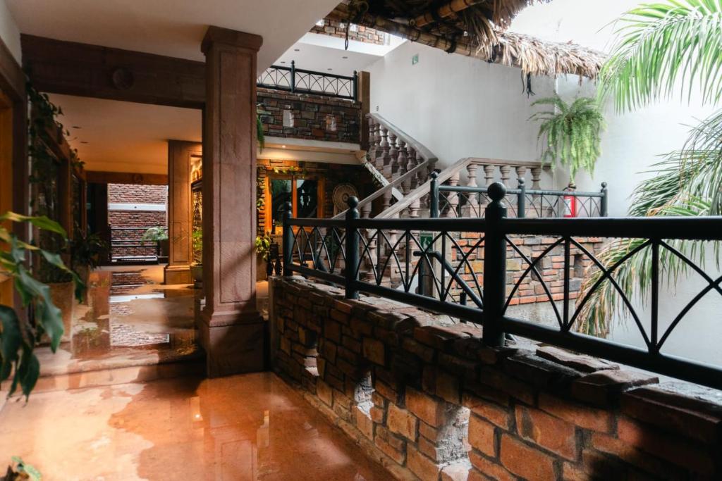 a building with a staircase and a brick wall at Hotel Boutique in Querétaro
