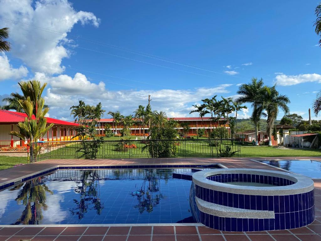 a swimming pool in front of a resort at Hotel Campestre San Fernando in La Paloma