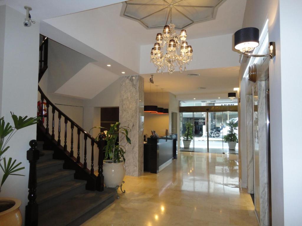 pasillo con escalera y lámpara de araña en Hotel Napoleón en Buenos Aires