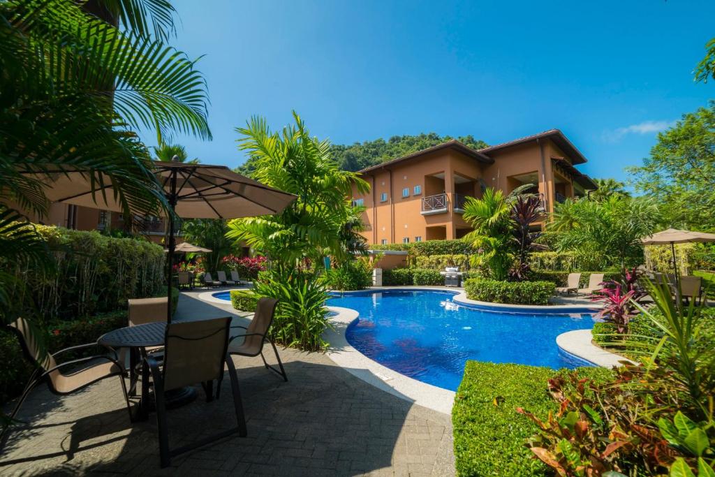 a villa with a swimming pool in a resort at Veranda 3B 2 bdr Garden View in Los Suenos in Herradura