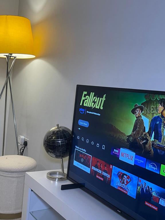 a flat screen tv sitting on top of a table at Wilsuel Haven-2Bedroom Aprt in Wolverhampton