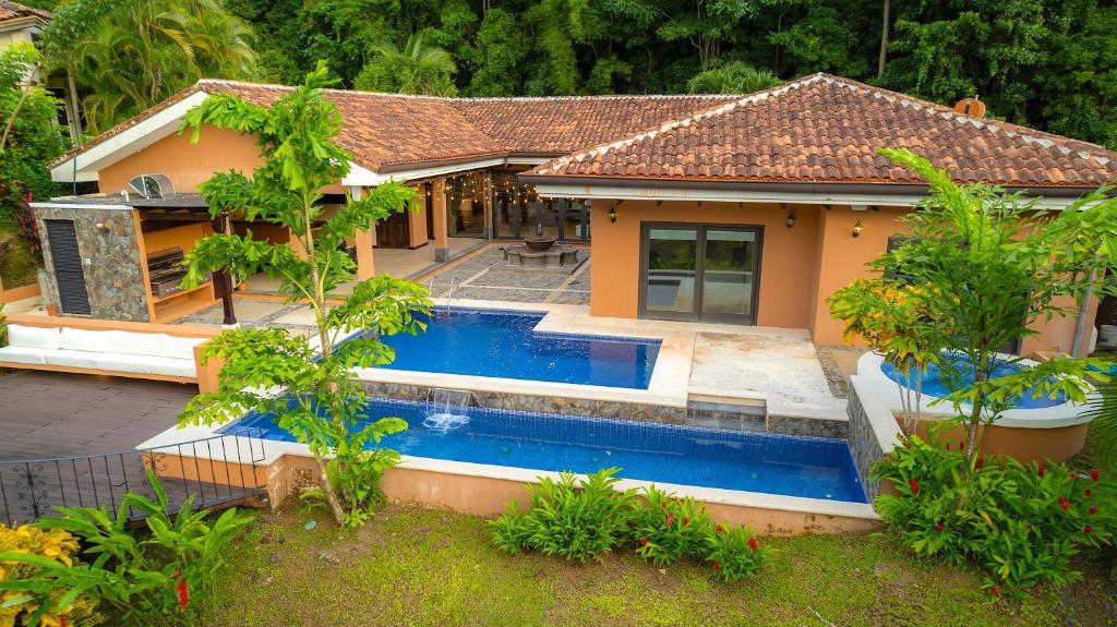 a house with a swimming pool in the backyard at Casa Plazoleta 4 bdr private pool in Los Suenos in Herradura