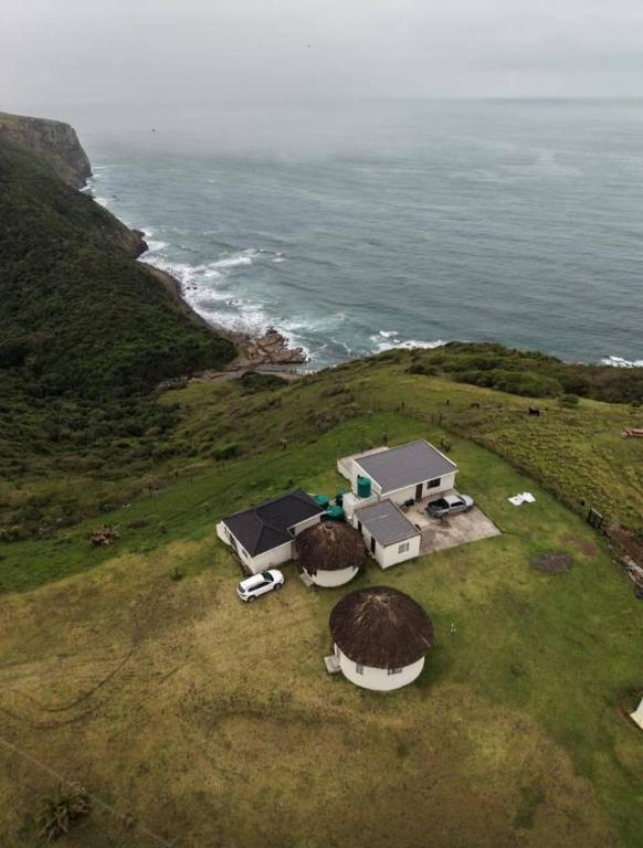 an aerial view of a house on a hill next to the ocean at Sunrise On Sea Backpackers in Port St. Johns