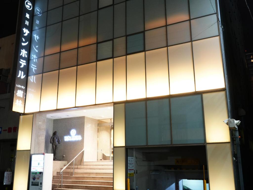 a building with a staircase in front of it at Asahikawa Sun Hotel in Asahikawa