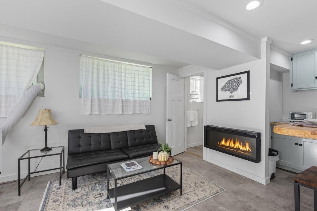 a living room with a couch and a fireplace at The Briarcliff Suite studio in Athens