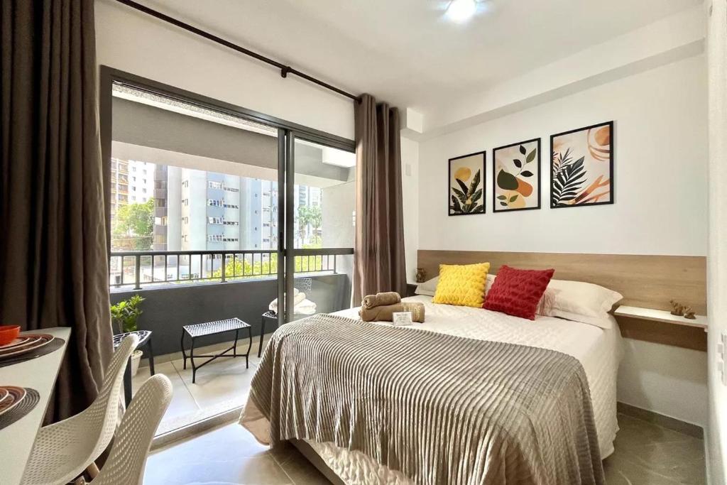 a bedroom with a bed and a large window at Studio Congonhas I SP Expo I Morumbis & Interlagos in São Paulo