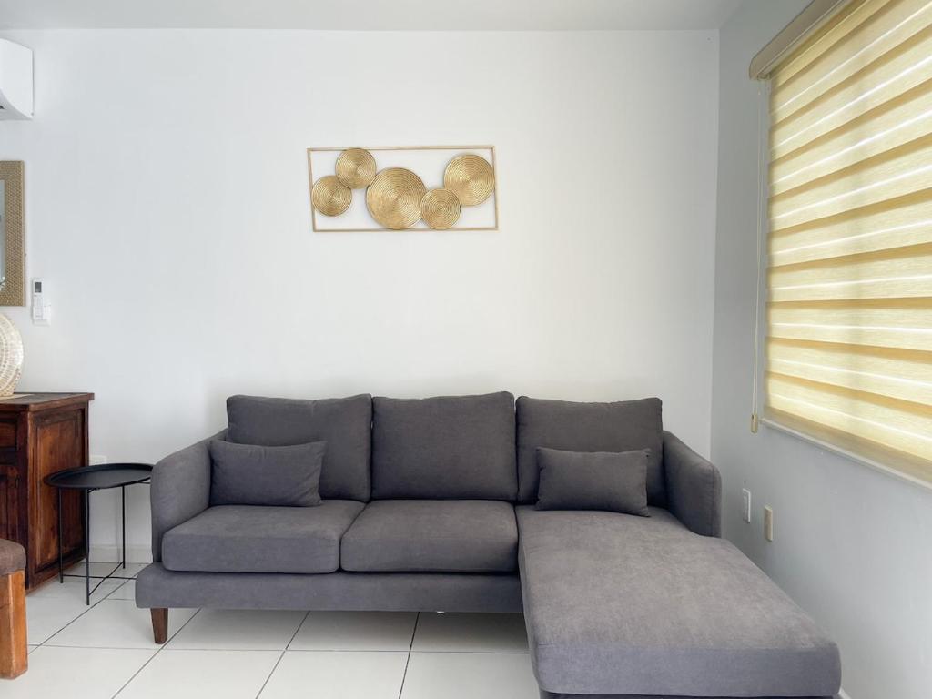 a living room with a gray couch in a room at Casa Coralina in San Carlos