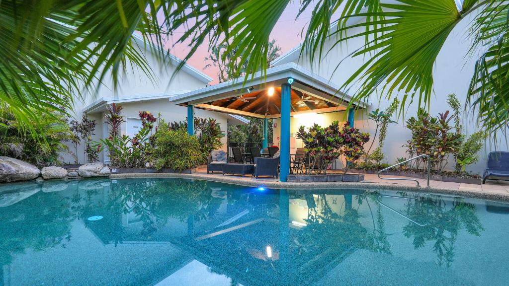a swimming pool in front of a house at Trinity Beach Pacific in Trinity Beach