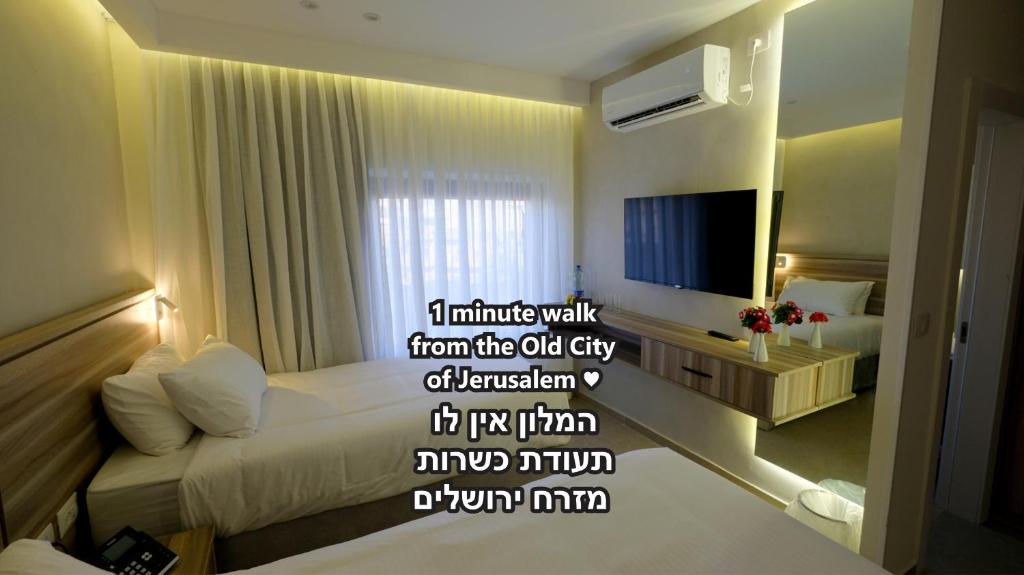 a hotel room with a bed and a television at Jerusalem Jasmine Hotel in Jerusalem