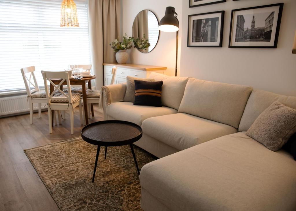 a living room with a couch and a table at Justina's House in East Kilbride