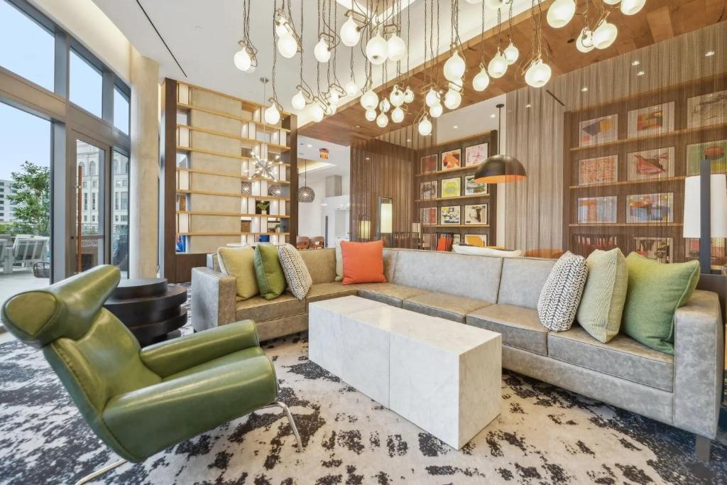 a living room with a couch and a chair at Penthouse Retreat with Rooftop Pool Explore Silver Spring & Washington DC in Silver Spring
