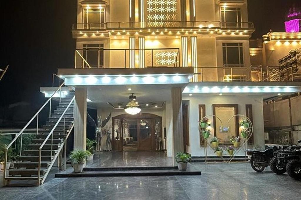 a large building with a staircase and a stair case at Hotel Beubelle in Meerut